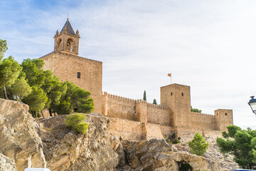 Fototapeta premium Alcazaba de Antequera. old medieval castle. stone walls, towers, stone buildings. horizontally and vertically, sunlight, blue sky and clouds