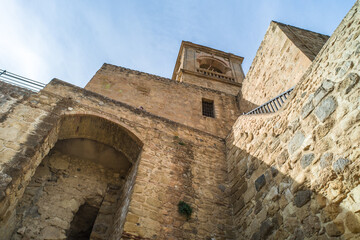 Obraz premium Alcazaba de Antequera. old medieval castle. stone walls, towers, stone buildings. horizontally and vertically, sunlight, blue sky and clouds