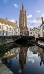 Fototapeta na wymiar Bruges, Belgium: view of the canal and the Church of our Lady on background 