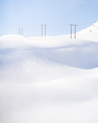 Powerlines in snowy norwegian mountains