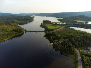 Fototapeta na wymiar Droneshot of norwegian lake with crossing railway track