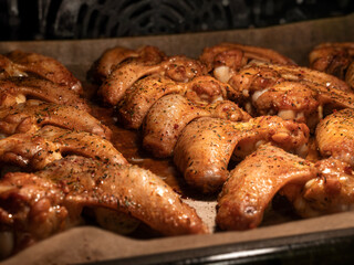 Cooking chicken wings in oven. Baking dinner for holiday celebration