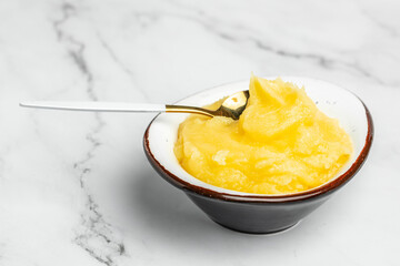 Homemade Melted ghee clarified butter. Bio Ayurveda Lactose free high quality butter on a light background. place for text, top view