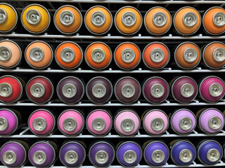 Stack of colorful air spray paint cans