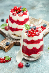 Scottish dessert whipped cream, roasted oatmeal and raspberries in jar. banner, menu, recipe place for text, top view