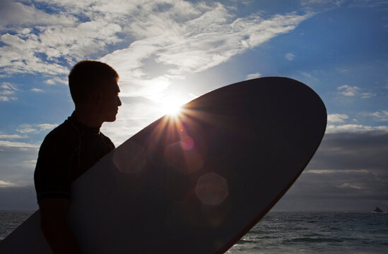 Silhouette of a Lone Surfer looking out to sea, Cornwall ,UK