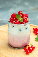 raspberries yogurt. Healthy breakfast Greek yogurt with raspberries and mint in a glass. Berry smoothie. healthy dieting concept