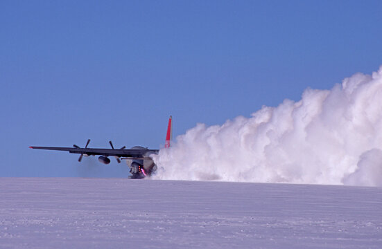 A C-130, (on skis), uses Assited Takeoff Jet Bottles to boost the takeoff from a remote field camp, Antarctica