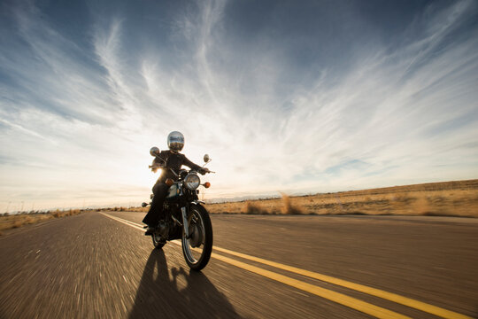 Woman Riding The Open Road On Her Vintage Motorcycle During Sunset In Denver, Colorado.