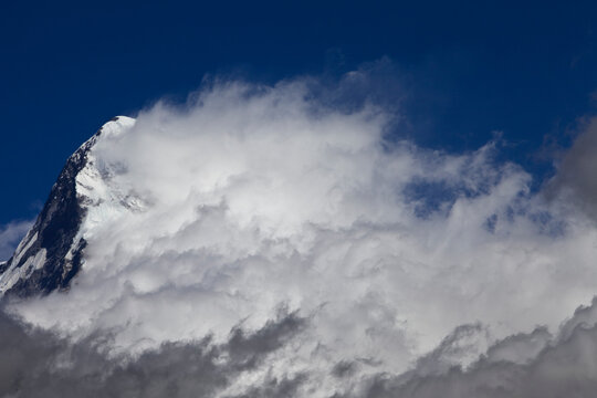 A cloud system builds from the south face of Annapurna South.