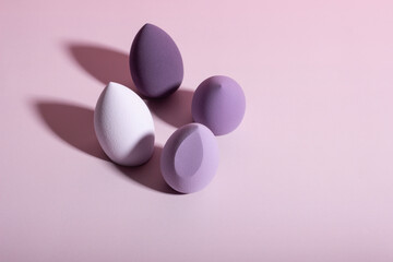 Purple make-up sponges. Concept of beauty, makeup and beauty salon