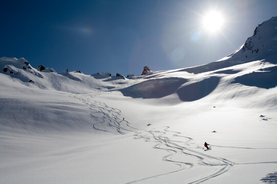 Man skis down hill in Alaska backcountry near Alaska Canada border