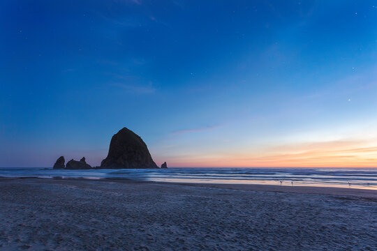 Twilight in Cannon Beach, OR with Haystack rock in the foreground