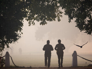 Silhouette of man walking outdoors, New Delhi India.