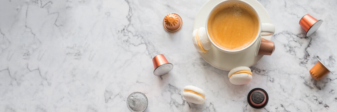 Cup of espresso, black coffee served with pods and capsules on marble table.Collection of espresso coffee capsules.Caffeine, hot drinks and objects concept.pods for coffee mashine