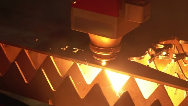 Automatic cnc laser cutting machine working with sheet metal with many sparks at factory, Cut Metal Material Laser Burn Closeup Shot, plant - slow motion.
