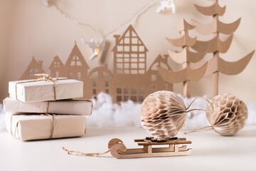 DIY Christmas home decor - paper ball on sledge, craft paper gifts, cardboard tree and house.