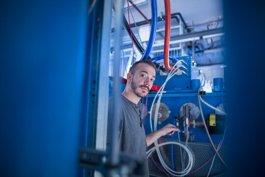 Portrait of a young male engineer working in an industrial plant, Freiburg im Breisgau, Baden-W&uuml;rttemberg, Germany
