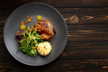Baked duck leg with herbs and sauce