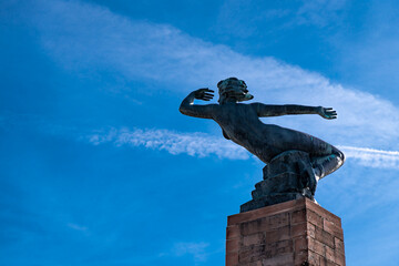 Statue looking into the blue sky