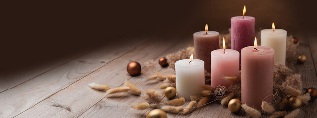 Natural Christmas Advent candles decoration in warm trend colors with dried lagurus and pampas grass on wood background. Winter cozy style, Hygge concept. - 546660513