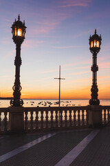 Sunset in La Caleta, beautiful light, bobbing boats and atmospheric street lighting