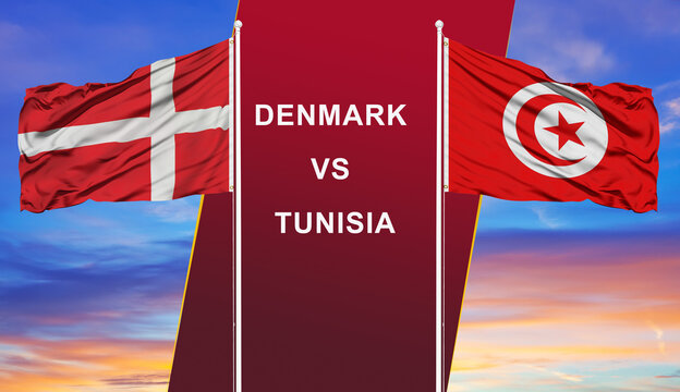 Denmark vs. Tunisia two flags on flagpoles and blue cloudy sky background.Soccer matchday template