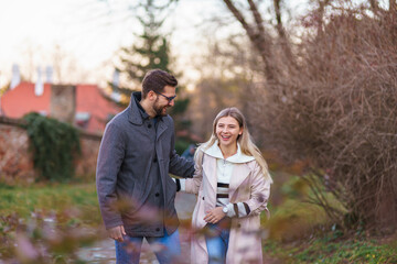 A portrait of a happy romantic couple walking outdoors in the surroundings of an old fortress