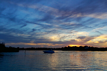 Boats silhouetted against the sunset, Tarpon Springs, Florida, Anclote River