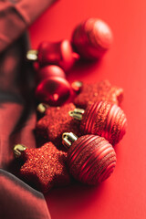 Red christmas decoration. Christmas bulbs on red background.