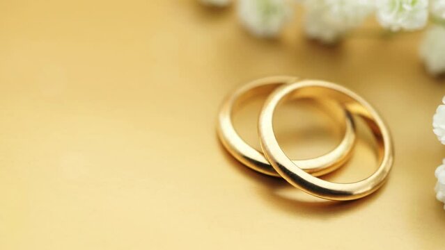 Gold wedding background with rings and soft light effects copy space for wedding invitation photo animation