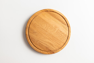 Empty wood round cutting board on white background