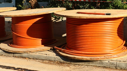 Optical fiber cable drums waiting for installation on the curbside