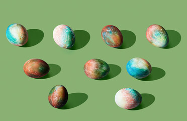 Pattern of easter eggs on green pastel background