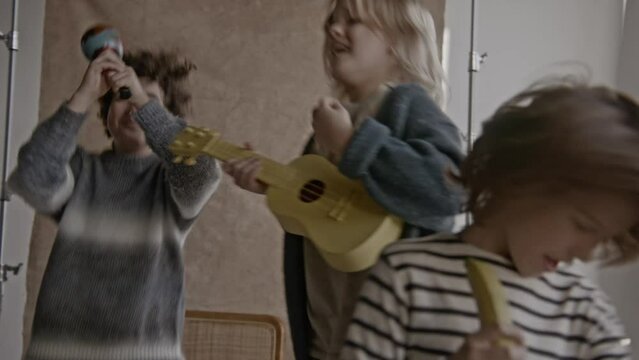 Three young boys rocking out together in a band