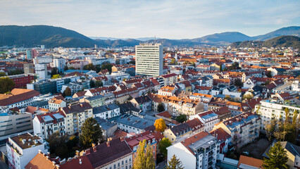 Fototapeta na wymiar Aerial view of the Gries district in Graz, Austria. A high office building surrounded by lower houses as an architectural eyesore