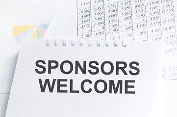 SPONSORS WELCOME text on notebook on a white background