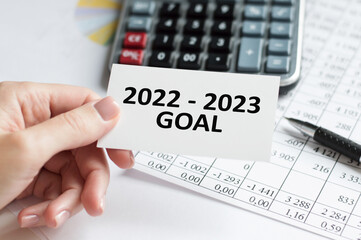 Businessman holds a card with the inscription 2022-2023 goals, business concept