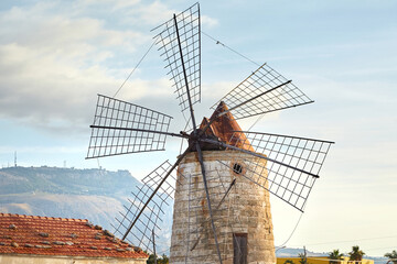 Windmill in the Saline di Trapani e Paceco natural reserve near Trapani, Sicily, Italy. Old...