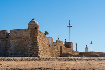 This the Bastion of  OrejÛn, one of the bastions build for the defense of La Caleta. Next to it is the buste of Paco Alba, one of the 'fathers' for modern day Carnaval in C·diz - obrazy, fototapety, plakaty