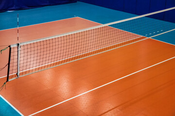Volleyball court with net in old school gym, top view, copy space. Backdrop sports image of...