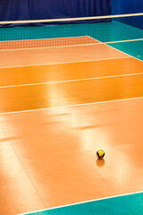 Backdrop sports image of volleyball courts with ball in sports hall. Volleyball court with net in...