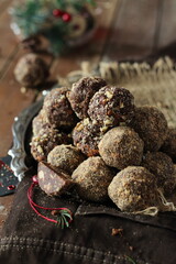 Chocolate truffles with walnut sprinkles on a silver platter, Christmas table decoration, something sweet to go with your coffee. 