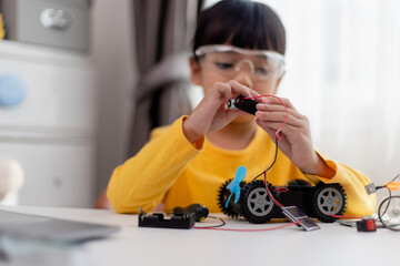 Asia students learn at home in coding robot cars and electronic board cables in STEM, STEAM,...