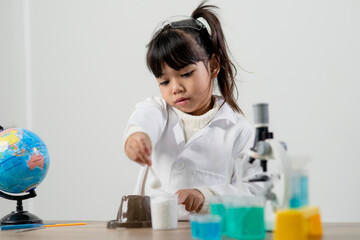 education, science, chemistry and children concept - kids or students with test tube making experiment at school laboratory