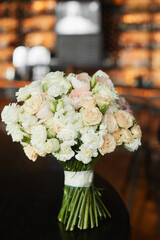 Luxurious bridal bouquet of fresh flowers. Wedding bouquet of the bride. Bridal bouquet of fresh roses and peonies flowers and green branches