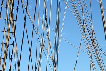 Lots of ropes from a ship intertwining, a ladder, ropes clumped together create for an interesting...