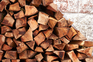 A woodpile by the wall of the dwelling. The firewood is laid in advance and prepared for winter to...