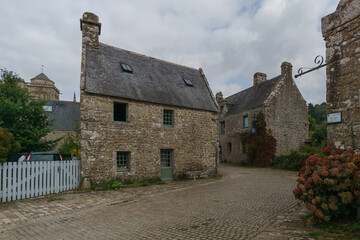 Fototapeta na wymiar Medieval street with cobbles and a house in the small beautiful village of Locronan, Brittany, France