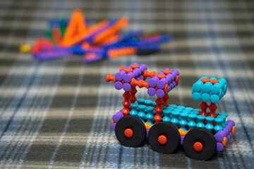 Banchamm construction constructor for children. A locomotive made of multicolored parts of the designer. Games that develop fine motor skills in a child.